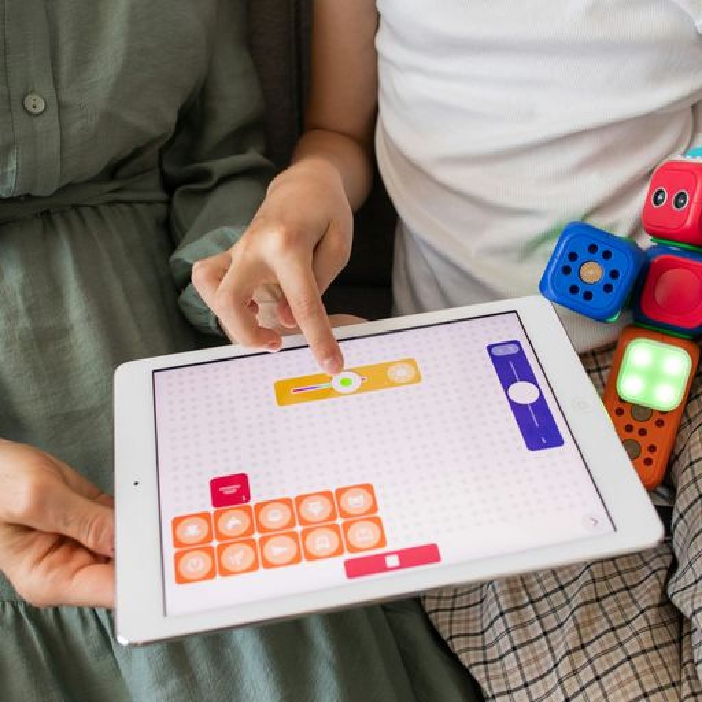 child playing game on white ipad