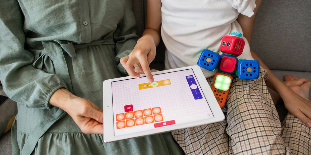 child playing game on white ipad